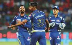  ?? AP, AFP Courtesy: IPL ?? Brendon McCullum (left) and skipper Virat Kohili (centre) put Royal Challenger­s Bangalore on a firm footing against Mumbai Indians before Hardik Pandya struck three wickets in one over to restrict the hosts to 167 for seven in 20 overs. Colin de...