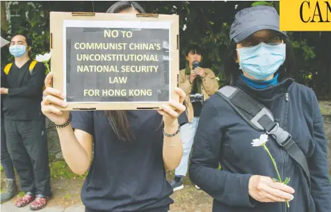  ?? ARLEN REDEKOP / POSTMEDIA NEWS FILES ?? Anti-Chinese government activists protest outside of the Consulate General of the People's Republic of China in Vancouver earlier this year.