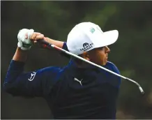  ?? Associated Press photo ?? Rickie Fowler hits on the second hole during the third round at the Masters golf tournament Saturday in Augusta, Ga.