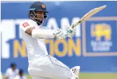  ?? — AFP ?? Sri Lanka’s Dimuth Karunaratn­e plays a shot during the first day of their opening Test match against South Africa in Galle on Thursday.