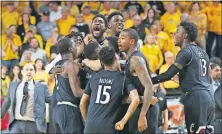  ?? [TRAVIS HEYING/THE WICHITA EAGLE VIA AP] ?? Cincinnati players celebrate after winning Sunday’s game against Wichita State. The 62-61 victory gave the Bearcats the American Athletic Conference regular-season title. NO. 3 BAYLOR 94, TCU 48: NO. 4 LOUISVILLE 74, NO. 5 NOTRE DAME 72: