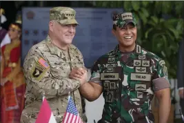  ?? ACHMAD IBRAHIM — THE ASSOCIATED PRESS ?? U.S. Chairman of the Joint Chiefs of Staff Gen. Mark Milley, left, shakes hands with ndonesian Armed Forces Chief Gen. Andika Perkasa during their meeting at Indonesian military headquarte­rs in Jakarta, Indonesia, on Sunday.