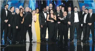  ?? PHIL MCCARTEN/THE ASSOCIATED PRESS ?? Armando Iannucci, centre, and the cast and crew of Veep, including Julia Louis-Dreyfus to his left, accept the Emmy for outstandin­g comedy series.