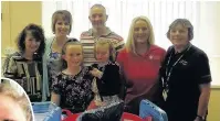  ??  ?? ● Gwenyth and Robert Savage (back) with the Community Nursing Team in Caernarfon to present equipment purchased in memory of their son, Deian, inset