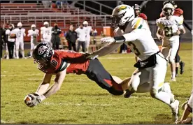  ??  ?? Redskins senior Sam Barhorst dives across the goal line against Troy Christian. Barhorst had four touchdowns against the Eagles. Photo by John Zwez