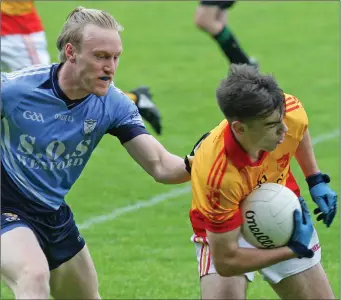  ??  ?? Dylan Furlong of Sarsfields shields the ball from St. Anne’s defender Diarmuid O’Keeffe.