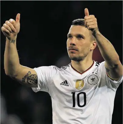  ??  ?? FOND FAREWELL: Lukas Podolski shows his appreciati­on to the Germany supporters in Dortmund last night