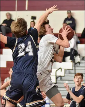  ?? BARRY TAGLIEBER - FOR MEDIANEWS GROUP ?? At left, Pope John Paul II’s Justin Green, right, goes to the hoop past Lower Moreland’s Joey Movozin in Saturday’s District 1-4A semifinal. At right, Pope John Paul II’s Jaden Workman, right, looks toward the hoop as Lower Moreland’s John Prez defends.