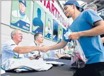  ?? BRAD HORRIGAN/HARFORD COURANT FILE ?? Former Whalers captain Mike Rogers, left, during a meet and greet as part of Hartford Whalers Alumni weekend at Dunkin’ Donuts Park in 2017.