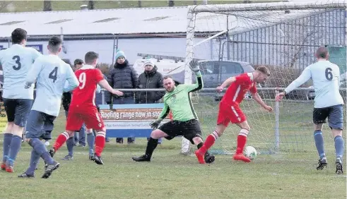  ??  ?? Llangefni (red) about to score against Penrhyndeu­draeth