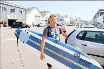  ?? PICTURE: TERRY HAYWOOD ?? SAFE, MY MATE: Durban surfer Izan Leibbrandt surfed his way down Hunter Street during the massive storm which hit the city on Tuesday. Check out Liebbrandt’s impromptu surf at www.bit.ly/DBNsurf