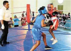  ?? Picture: SUE MACLENNAN ?? TRUE FIGHTERS: Port Alfred Cadet Owethu Mxuma faces Lizole Dyantyi, from Alice, in a hard-fought bout at the Hlalani Indoor Sport Centre in Makhanda on Saturday October 15