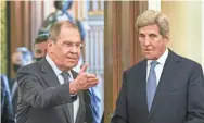  ??  ?? Russian Foreign Minister Sergey Lavrov, left, welcomes U.S. climate envoy John Kerry for talks in Moscow on Monday.