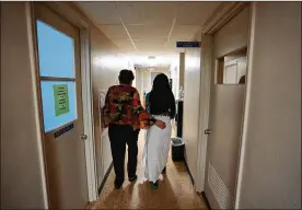  ?? REBECCA BLACKWELL/ASSOCIATED PRESS ?? A 33-year-old mother of three from central Texas is escorted by clinic administra­tor Kathaleen Pittman prior to getting an abortion Oct. 9 at Hope Medical Group for Women in Shreveport, La.