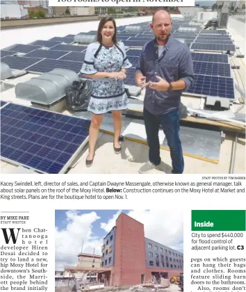  ?? STAFF PHOTOS BY TIM BARBER ?? Kacey Swindell, left, director of sales, and Captain Dwayne Massengale, otherwise known as general manager, talk about solar panels on the roof of the Moxy Hotel. Below: Constructi­on continues on the Moxy Hotel at Market and King streets. Plans are for the boutique hotel to open Nov. 1.