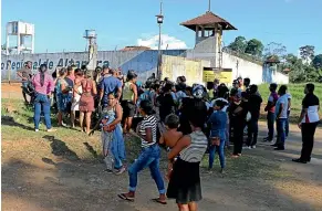  ?? AP ?? People seek informatio­n about family members who are prisoners after a riot inside the Regional Recovery Center in Altamira, Brazil.