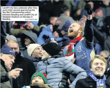  ?? ALEX PANTLING ?? Cardiff City fans celebrate after they score their second goal during the Sky Bet Championsh­ip match between Reading and Cardiff City at Madejski Stadium on Monday in Reading