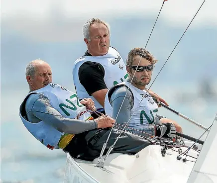  ?? HAGEN HOPKINS/GETTY IMAGES ?? Chris Sharp (L), Richard Dodson and Andrew May of New Zealand compete in the Para-Sailing Sonar class.