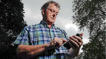  ?? [AP PHOTO] ?? Towne & Country Building Inspection owner Scot McLean looks at his calendar on Wednesday outside his Fox Point, Wis., home. Towne & Country downloaded several apps to enhance the Google calendar the company uses for customer appointmen­ts. In July,...