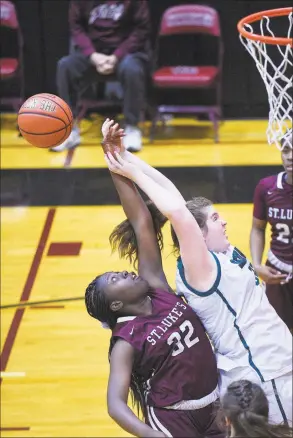  ?? Matthew Brown / Hearst Connecticu­t Media ?? St Luke’s Alexia Watson (32) battles for the rebound with Sacred Heart Greenwich’s Sarah Augustine (32) in the second half on Wednesday in New Canaan.