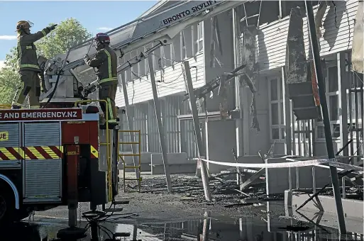  ?? ALDEN WILLIAMS/STUFF ?? Firefighte­rs survey the damage after the large fire at Linwood College early yesterday morning.