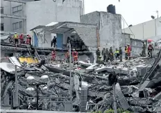 ?? AFP/GETTY IMAGES ?? Rescuers from Mexico and Israel search for survivors in a flattened building in Mexico City on Sept. 21 two days after a strong quake hit central Mexico. A powerful 7.1 earthquake shook Mexico City causing panic among the megalopoli­s' 20 million...