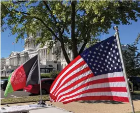  ?? Photograph: Oliva Rose Empson ?? Protesters fly the US and the Afghan flags in front of the Capitol.