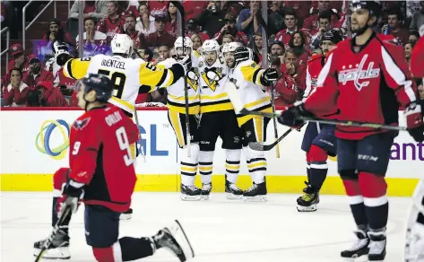  ?? PATRICK SMITH/GETTY IMAGES ?? Pittsburgh Penguins teammates celebrate Bryan Rust’s goal in the second period of Game 7 of their Eastern Conference semifinal series against the Washington Capitals on Wednesday in Washington, D.C. The Penguins won 2-0 and will next play the Ottawa...