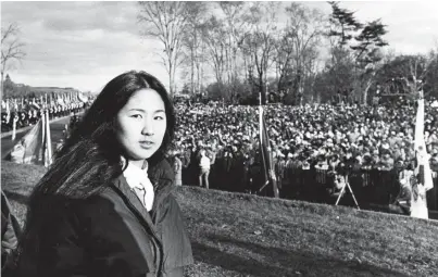  ?? HARRY NALTCHAYAN/THE WASHINGTON POST ?? Maya Lin, architect of the Vietnam Veterans Memorial, attends the dedication in 1982. A festival in her honor on Saturday accompanie­s the National Portrait Gallery exhibit “One Life: Maya Lin.”