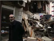  ?? (AP/Khalil Hamra) ?? A man walks past damaged shops Wednesday in Duzce, Turkey, after a magnitude 5.9 earthquake hit a town in northwest Turkey.