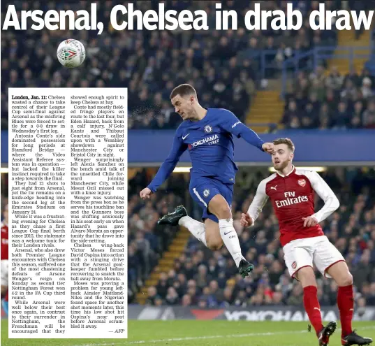  ?? — AFP ?? Chelsea’s Eden Hazard ( left) in action against Calum Chambers of Arsenal in their League Cup semi- final first leg match at Stamford Bridge in London on Wednesday. The match ended goalless.