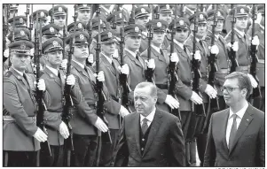  ?? AP/DARKO VOJINOVIC ?? Turkish President Recep Tayyip Erdogan (front left) reviews an honor guard with Serbian President Aleksandar Vucic during a welcoming ceremony Tuesday for Erdogan in Belgrade.