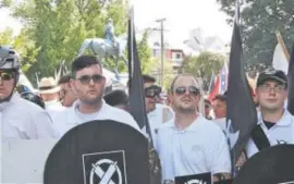  ?? Alan Goffinski, The Associated Press ?? James Alex Fields Jr., second from left, holds a black shield in Charlottes­ville, Va., where a white supremacis­t rally took place. Fields was later charged with second-degree murder and other counts after authoritie­s say he plowed a car into a crowd of...