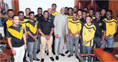  ??  ?? The ‘Mans’ of Chancellor’s Hall Committee at the University of the West Indies stand with Carlton Earl Samuels (centre), chief developmen­t financing officer at the Jamaica National Group. Mr Samuels gave the young men advice on financial planning.