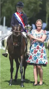  ??  ?? dance All Night and sammi Elliott stand ridden pony supreme and are awarded the hugely prestigiou­s dick saunders Trophy