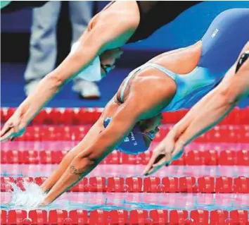  ?? AP ?? Brazil’s Etiene Medeiros (centre) launches into the pool during a women’s 50m freestyle heat.