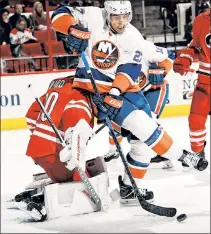  ?? Getty Images ?? CRASH LANDING: The Islanders’ Anders Lee collides with ’Canes goalie Cam Ward Tuesday.