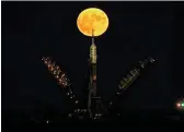  ??  ?? The supermoon behind the Soyuz MS-03 spacecraft which is set on the launch pad at the Russianlea­sed Baikonur cosmodrome in Kazakhstan