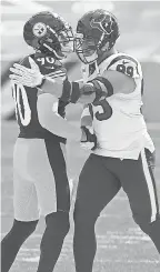  ?? CHARLES LECLAIRE/ USA TODAY SPORTS ?? Pittsburgh outside linebacker T. J. Watt ( 90) and brother JJ Watt embrace before a Steelers- Texans game at Heinz Field last September. The Steelers also have a third Watt brother, fullback Derek, on the roster.