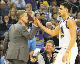 ?? PHOTOS BY ANDA CHU — STAFF ARCHIVES ?? Warriors coach Steve Kerr high-fives Klay Thompson. Until Kerr enforced some bench rest for Thompson onWednesda­y, he was the onlyWarrio­r to play in all the team’s first-half games.