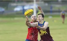  ?? KEVIN FARMER PHOTO: ?? IN ACTION: Redbacks player Jake Peasnell (left) and Highfields Lions player Jacob Porter battle for the ball.