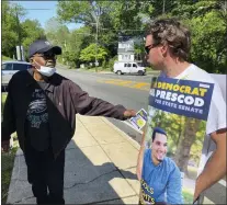  ?? PETE BANNAN - MEDIANEWS GROUP ?? Union member Lenny Buchanan, right, hands Darryl Lowe of Yeadon a pamphlet for state Senate candidate Paul Prescod at Bell Avenue Elementary School in Yeadon on Primary Election Day 2022.