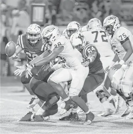  ?? Juan DeLeon photos ?? Klein Collins running back Isaiah Spiller (28) reaches for the ball after losing control during the second half against Klein at Memorial Stadium on Friday night. The Tigers improved to 8-0 with a 22-9 victory over their rivals.