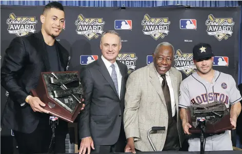  ?? ALEX GALLARDO/THE ASSOCIATED PRESS ?? Miami Marlins slugger Giancarlo Stanton, left, and Houston Astros infielder Jose Altuve show off their 2017 Hank Aaron Awards on Wednesday in Los Angeles with MLB commission­er Rob Manfred and the legendary Aaron himself.