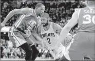  ?? AP/TONY DEJAK ?? Cleveland guard Kyrie Irving (center) drives between Golden State forward Kevin Durant (left) and Stephen Curry during Friday night’s Game 4 of the NBA Finals. Irving helped the Cavaliers stave off eliminatio­n for at least one more game with a...