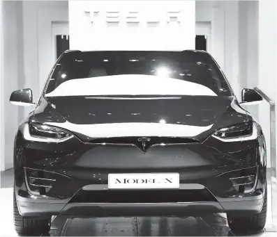  ??  ?? Tesla Model X electric car is showcased on September 30 at the Paris Internatio­nal Motor Show in France.