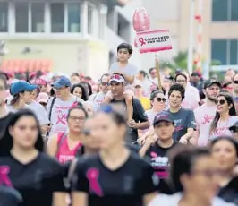  ?? MIKE STOCKER/SOUTH FLORIDA SUN SENTINEL ?? Participan­ts walk down Las Olas Boulevard in Fort Lauderdale in October 2019 during the Making Strides Against Breast Cancer 5K walk.