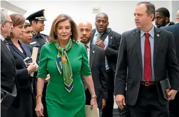  ?? AP ?? Speaker of the House Nancy Pelosi, D-Calif., joined by House Intelligen­ce Committee Chairman Adam Schiff, D-Calif., right, leaves a lengthy closed-door meeting with the Democratic Caucus at the Capitol in Washington yesterday.