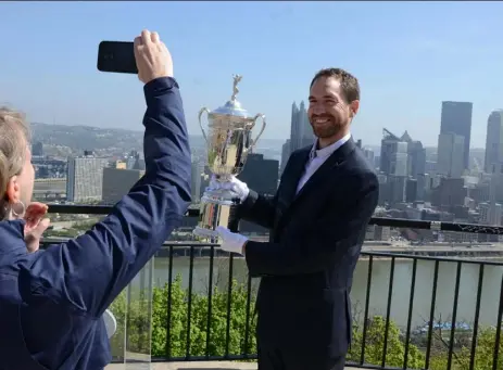  ?? Doug Oster/Post-Gazette ?? WIDE OPEN
Michael Trostel, historian for the United States Golf Associatio­n, poses for a picture with the U.S. Open trophy on Mount Washington Friday. The trophy is on a cross-country journey from the USGA’s New York home to Chambers Bay, Wash., where...