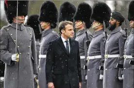  ?? ALASTAIR GRANT / ASSOCIATED PRESS ?? French President Emmanuel Macron inspects the Coldstream Guards’ honor guard Thursday as he and British Prime Minister Theresa May arrived for a summit at the Sandhurst military academy in Camberley, England.